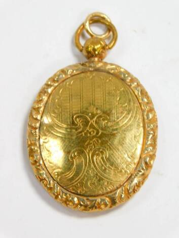 A Victorian pinchbeck photo locket, of oval form, floral and foliate engraved, with shield reserve within an embossed floral border, 42mm H.