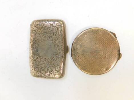 A George V silver cigarette case, foliate engraved, circular reserve, Birmingham 1920, and a George VI silver compact, with engine turned decoration, Birmingham 1945, 3.39oz. (2)