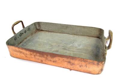 A French 19thC copper roasting tin, with twin brass handles, stamped Bain Ovonne, 68cm x 42.5cm.