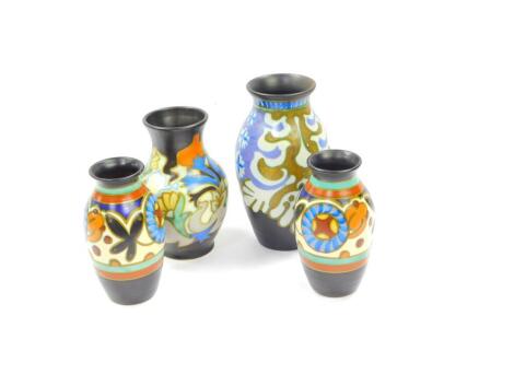 Four Gouda pottery vases, decorated in the Louvre pattern, 306, largest 14cm high.