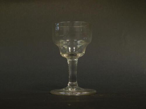 A George III late 18thC dram glass, the ogee shaped bowl raised on a straight stem above a conical folded foot, 9cm H.