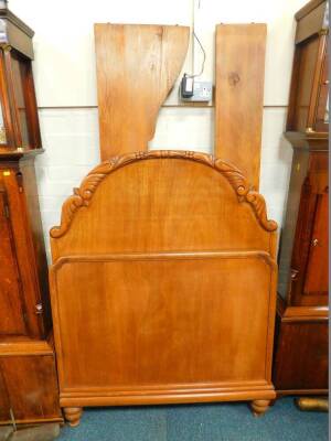 A Continental mahogany and pine single bed, with a period carved headboard, raised on turned feet.