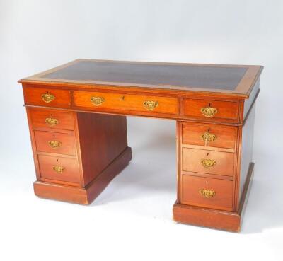 A Victorian mahogany twin pedestal desk, the rectangular top inset with tooled purple leather, over one long and two short drawers, above six graduated drawers, raised on plinth bases, on castors, 72.5cm high, 122.5cm wide, 64cm deep.