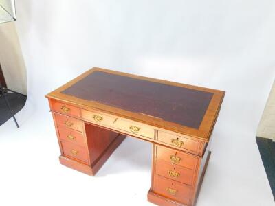 A Victorian mahogany twin pedestal desk, the rectangular top inset with tooled purple leather, over one long and two short drawers, above six graduated drawers, raised on plinth bases, on castors, 72.5cm high, 122.5cm wide, 64cm deep. - 2