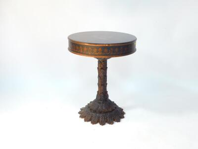 An Adam style wooden and plaster drum table, the circular top printed with classical paterae and swags, raised on a relief moulded stem and two tier relief moulded circular base, 69.5cm high, 55.5cm diameter.