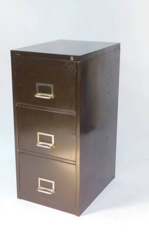 A brown metal three drawer filing cabinet, with keys, 100.5cm H, 47cm W, 51.5cm D.