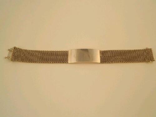 A heavy mesh link and solid bar bracelet with tongue and clip clasp