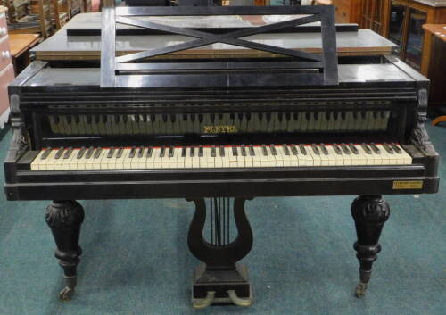 A Pleyel Paris France baby grand piano, in ebonised case with an adjustable music stand, marked to the interior IB & 02 London 1761 and 12 2/3, overstrung, on metal ground, with baluster shaped legs terminating in castors, 94cm high, 136cm wide, 198cm dee