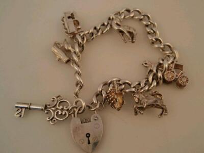 A silver charm bracelet with eight silver charms