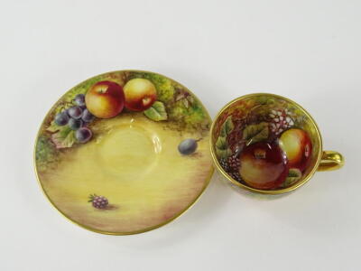 A 20thC Royal Worcester cabinet cup and saucer, by James Skerrett, hand painted with brambles and apples, the saucer 9cm diameter, printed marks beneath. - 2