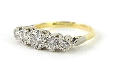 An 18ct gold five stone diamond ring, the five graduated illusion set diamonds, on a part pierced shank in platinum, the largest round brilliant 3.2mm x 1.8mm, approx 0.12cts, the next layer 2.8mm x 1.2mm, approx 0.06cts, the smallest 2.4mm x 1mm, approx 