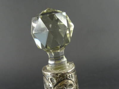 A late 19thC cut glass perfume bottle, with white metal repousse decorated collar, orb stopper and trumpet shaped body, decorated with a repeat hob nail cut geometric pattern, unmarked, 23cm high. - 2