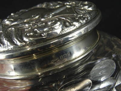 An Elizabeth II silver and cut glass powder box, the lid heavily repousse decorated with scrolls, the main section of compressed form hob nail cut with a repeat geometric pattern, the lid Birmingham 1958, 7cm high, 3½oz. - 2