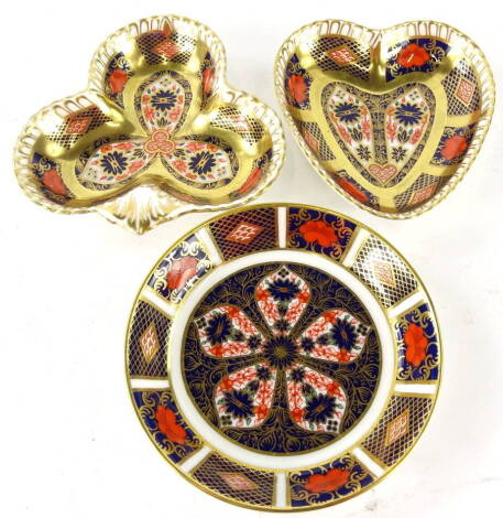 A Royal Crown Derby Old Imari pattern heart shaped dish, 10cm wide, a circular saucer and a clover leaf dish, printed marks beneath (3).