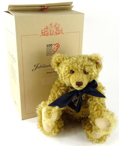 A Steiff 100 year anniversary blonde teddy bear, with blue bow and growl action, 44cm (boxed, with certificate)