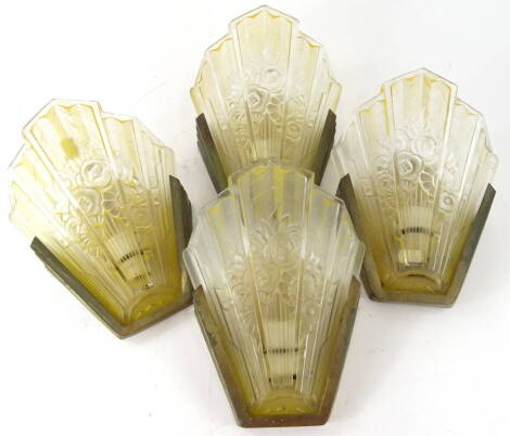 A set of four 20thC Art Deco glass fronted wall sconces, each with fan shaped yellow and clear glass moulded shades, set with flowers, on metal backs, with original fittings, 27cm high.