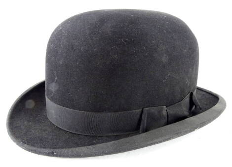 A G.A. Dunn & Sons bowler hat, in black with ribbon bow, 12cm high, interior measurements 21cm x 16cm.