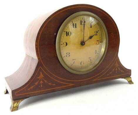 An Edwardian mahogany and boxwood strung mantel clock, the shaped case on metal stylised bracket feet, revealing an 8cm Arabic dial, with eight day movement, the case 15cm high, 23cm wide, 7cm deep, with fitted key.