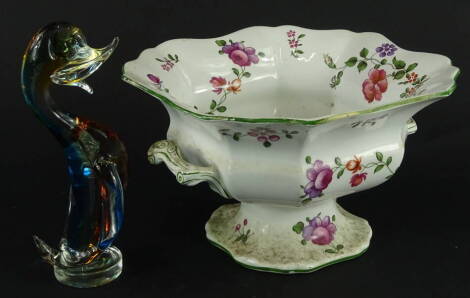 A 20thC transfer printed pottery footed tureen, of shaped form, polychrome decorated with flowers, with bark shaped handles, on a shaped foot, unmarked, 15cm high, 24cm wide, 23cm deep and a Murano glass figure of a standing duck in swirl blue amber and c