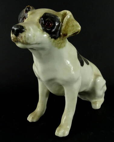 A Winstanley pottery figure of a standing dog, with glass eyes, black and white coat, marked beneath, 26cm high.