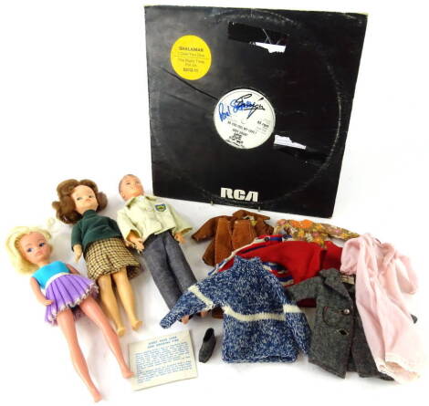 Various dolls, a Celluloid boy doll in clothing, 30cm high, various other clothing, Sindy type etc., an RCA 45rpm Eddie Grant Ice record bearing unknown signature (a quantity).