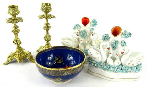 A 20thC Carltonware Bleu Royale bowl, of circular form, 13cm diameter, a pair of 19thC Staffordshire swan spill vase groups, polychrome decorated predominately in orange and turquoise and a pair of Baroque design brass candlesticks (5).