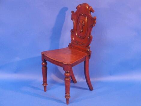 A Victorian mahogany shield back hall chair with a panel seat