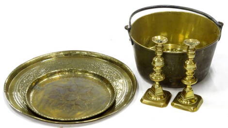 An early 20thC brass jam pan, Eastern tray and two baluster shaped candlesticks, on shaped feet, 23cm high (a quantity).