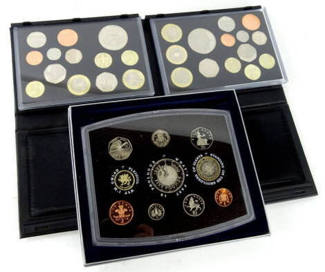 A United Kingdom 2010 proof coin set, in outer box and card packaging, another for 2011 and a further 2000 coin set (3)