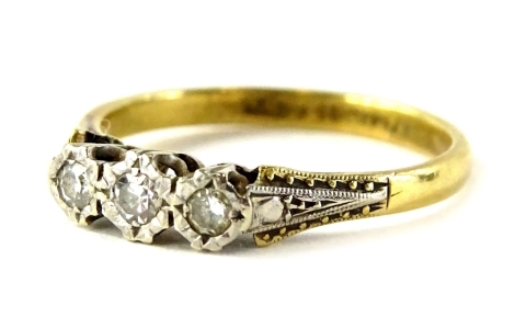 An 18ct gold and platinum diamond dress ring, set with three illusion set diamonds, in an Art Deco style setting, ring size M½, 2.6g all in.