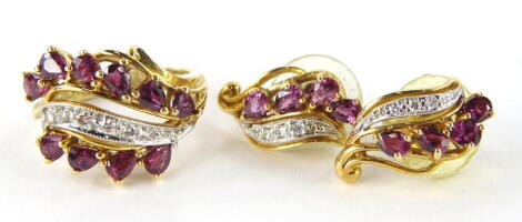 A 15ct gold jewellery set, comprising ring and a pair of earrings, each set with a swirl pattern of diamonds and claw set pink stones, marked 585, the ring size O, 11.5g (3).