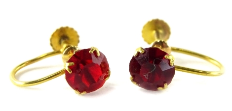 A pair of paste set earrings, each set with red paste stone, in yellow metal setting, stamped 9ct, with screw backs, 1.1g all in.