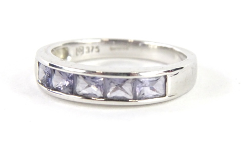 A 9ct white gold dress ring, with baguette cut purple stones, size O, 3.2g all in.