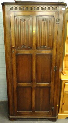 A 20thC oak linen fold hall wardrobe, 181cm high, 90cm wide, 63cm deep.