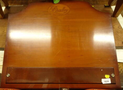 A Bradley yew veneered table top desk or book stand, the hinged lid enclosing a vacant interior, stamped by the manufacturer Made In England, 57cm wide.