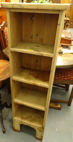 A pine narrow cabinet, set with four open shelves, on shaped block feet, 122cm high, 37cm wide, 25cm deep.