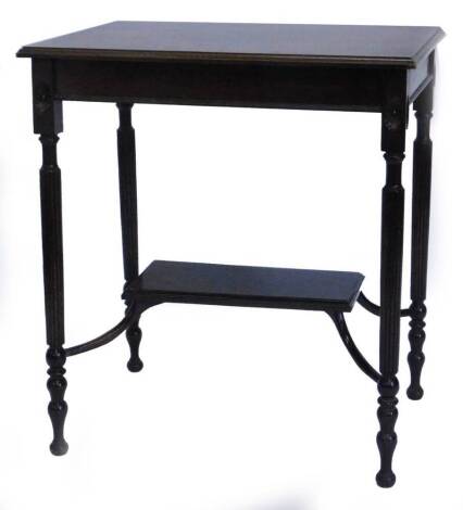 An Edwardian mahogany occasional table, the rectangular top with a moulded edge on reeded legs, headed by patera joined by a rectangular under tier, 65cm wide.