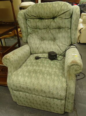 A Celebrity electric reclining chair in green diamond pattern material, 102cm high.