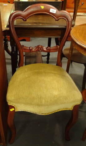 A Victorian walnut balloon back chair, with a padded seat on cabriole legs.