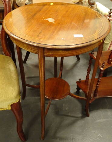 An Edwardian mahogany boxwood strung and chequer banded occasional table, the circular top with moulded edge on splayed supports, joined by a central under tier, 53cm diameter.