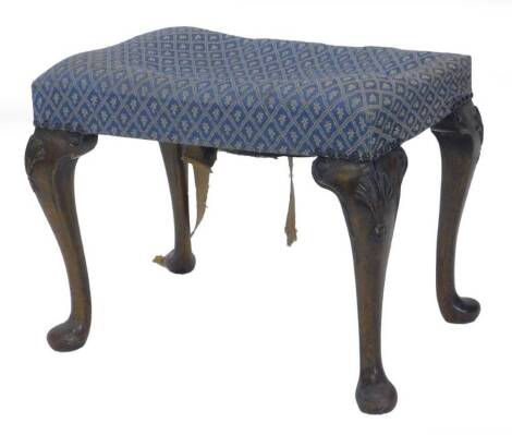 A walnut rectangular stool in George III style, with a padded seat on cabriole legs headed by carved fans with pad feet.