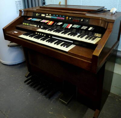 A Leslie Animation electric organ, with two banks of keys, further buttons and eight small and one large pedal, 115cm wide.