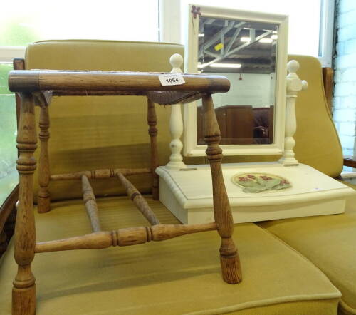 A light oak foot stool of shaped scroll form with bergere top, 36cm high, 47cm wide, 38cm deep and a table mirror with glove box, partially painted and set with flowers.