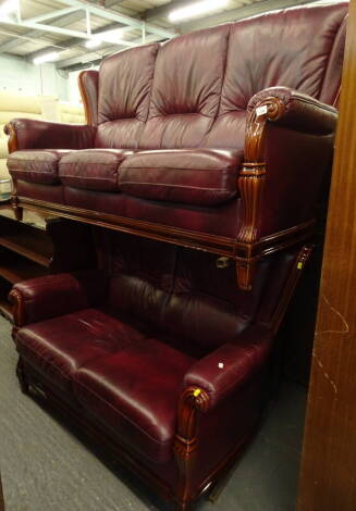 A two piece lounge suite comprising three seater and two seater settees in crimson leather, 183cm wide (2)