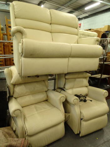 A three piece cream leather suite, comprising two seater settee, 144cm wide and two electric reclining armchairs (3).