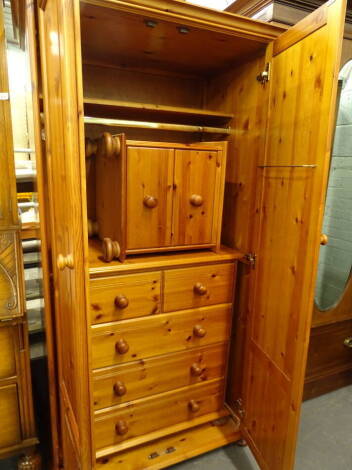 Pine bedroom furniture, comprising a two door wardrobe, two drawer pedestal cabinet, 48cm high, 46cm wide, 42cm deep and a chest of two short and three long drawers (a quantity).