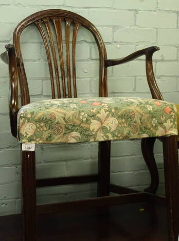 A 19thC mahogany open armchair, with a vase shaped splat, and a padded seat on channelled legs with H stretcher, 54cm wide.