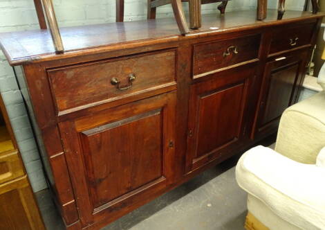 A hardwood dresser base, with a moulded and cleted top, above three frieze drawers and three panel doors, on square tapering legs, 101cm high, 190cm wide, 49cm deep.