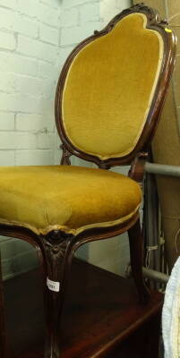 A Victorian rosewood side chair, the cartouche shaped back carved with scrolls, leaves and flowers with a padded back and seat on cabriole legs, 106cm high.