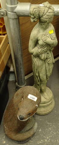 A garden statue of an otter, 33cm high, another classical modern stone figure of a lady semi clad.